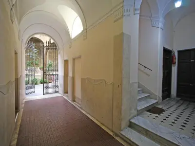 an empty hallway of a building with a door and stairs at Domus Navona Pantheon in Rome
