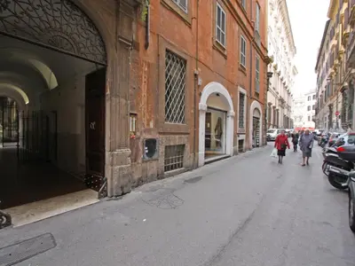 people walking down a city street with buildings at Domus Navona Pantheon in Rome
