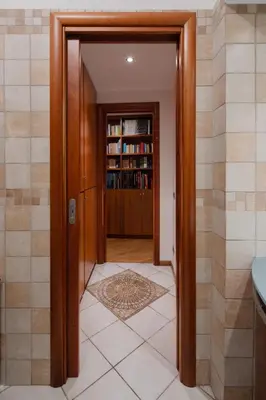 a hallway with a door leading to a book shelf at Francesco Terrace - Piazza Bologna, Rome in Rome