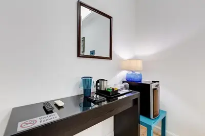 a room with a desk with a coffee maker and a mirror at Ripetta Central Suites in Rome