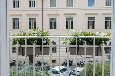 a balcony with white flowers and a building at MysuiteRome in Rome