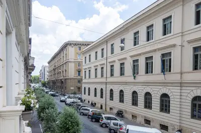a city street with cars parked next to buildings at MysuiteRome in Rome