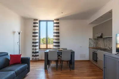 a kitchen and living room with a table and chairs at GuestHost - MM San Giovanni Apartment in Rome