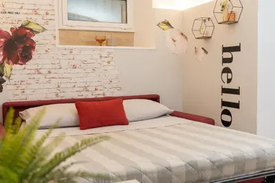a bedroom with a bed and a brick wall at Casa ZOE in Rome