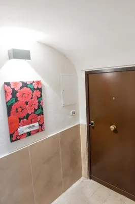 a picture on the wall next to a door at Casa ZOE in Rome