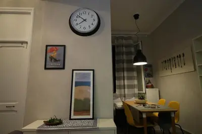 a room with a table and a clock on the wall at Charming house in Rome