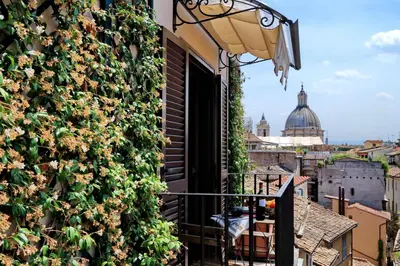a balcony with plants on the side of a building at Terrazze Navona in Rome