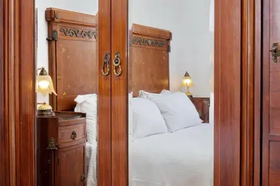 a bedroom with a bed with a wooden headboard at Terrazze Navona in Rome
