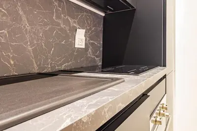 a kitchen with a granite counter top with a laptop on it at RANALLI Suite in Rome