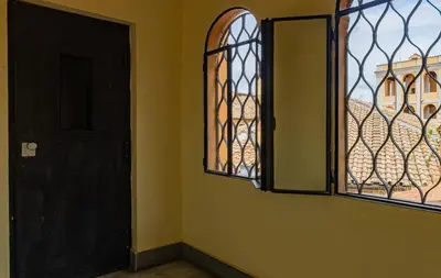 an empty room with a door and a window at RANALLI Suite in Rome