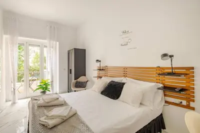 a bedroom with a large bed with a wooden headboard at B&Baldo Vatican in Rome