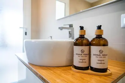 two bottles of wine sitting on a counter in a bathroom at SKY DOMUS ROME Historic Center Penthouse With Jacuzzi in Rome