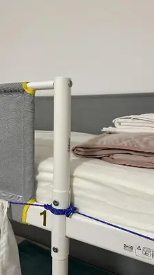 a white bed with a rope around it at Lisa HOUSE in Rome