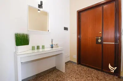 a bathroom with a sink and a wooden door at MrBrown - Pincherle Room in Rome