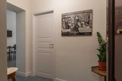 a white door in a room with a picture on the wall at Casa Enea - Pretty Homes in Rome