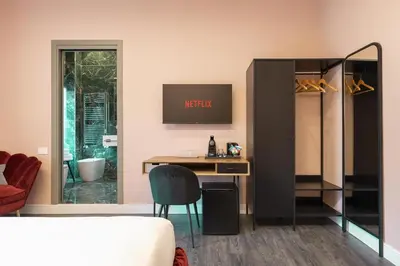 a room with a desk and a chair and a mirror at My Rooms in Vatican City in Rome