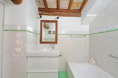 a white bathroom with a sink and a mirror at Leonina Terrace - My Extra Home in Rome