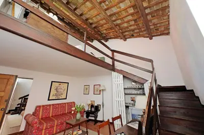 a living room with a staircase and a couch at Leonina Terrace - My Extra Home in Rome