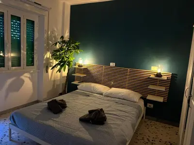 a bedroom with a bed with two hats on it at Alloggio turistico Gloria in Rome