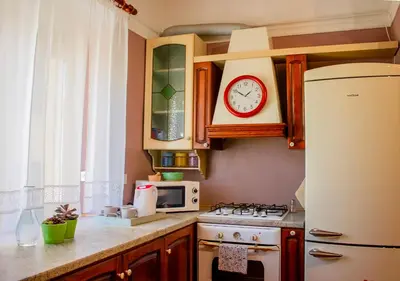a kitchen with a stove and a clock on the wall at Luminoso a due passi da Piazza Bologna in Rome