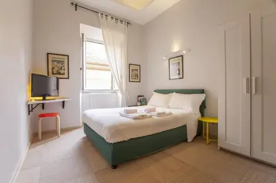 a patio with a table and chairs and plants at Babbo Guest House in Rome
