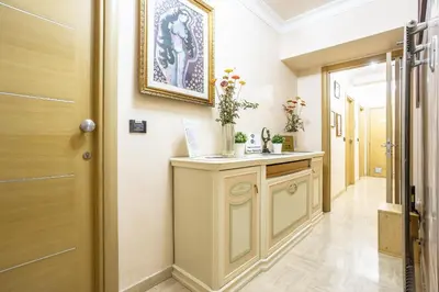 a hallway with a vanity with flowers on it at Opera Theater Relais in Rome