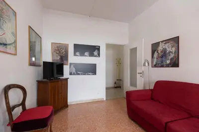 a living room with a red couch and a tv at Casa Lilly, appartamento luminosissimo a Roma in Rome