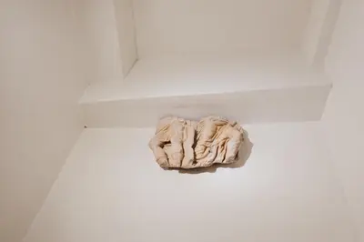 a statue sitting on the floor of a room at PAX apartment in Rome