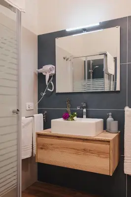 a bathroom with a white sink and a mirror at PAX apartment in Rome