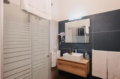 a bathroom with a sink and a mirror at PAX apartment in Rome
