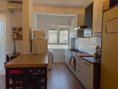 a kitchen with a refrigerator and a counter top at Appartamento con vista Vaticano in Rome