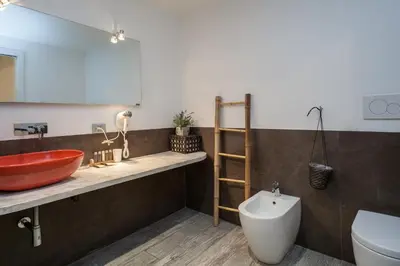 a bathroom with a vessel sink and a toilet at Flat 285 La Suite in Rome