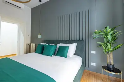 a bedroom with a large bed with green pillows at Angela luxury home,Premium Apartment for families in Rome