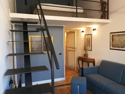 a living room with a couch and a loft bed at QUIRINALE 56 suite in Rome