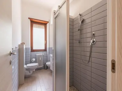 a bathroom with a toilet and a shower at The Best Rent - Spacious flat a stone's throw from the Vatican in Rome