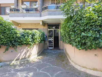 a building with a door and ivy at The Best Rent - Spacious flat a stone's throw from the Vatican in Rome