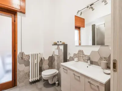 a bathroom with a toilet and a sink at The Best Rent - Spacious flat a stone's throw from the Vatican in Rome