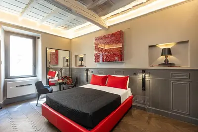 a bedroom with a large bed with red pillows at Amazing Piazza di Spagna in Rome