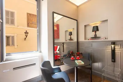 a room with a mirror and a table and chairs at Amazing Piazza di Spagna in Rome