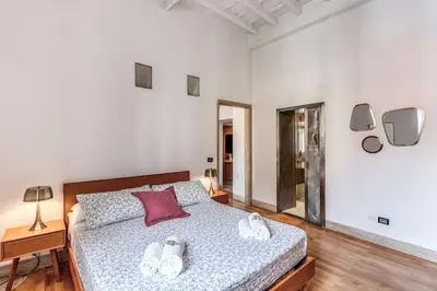 a bedroom with a bed with shoes on it at Trastevere at Piazza Giuditta Arcuati suite in Rome
