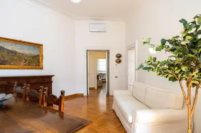 a living room with a white couch and a table at Adriana Star luxury large and central in Rome