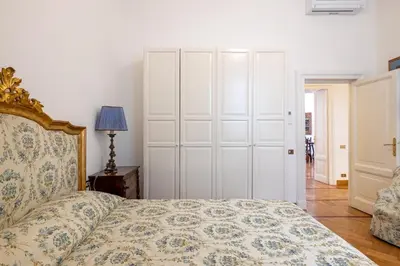 a bedroom with a bed and a white closet at Adriana Star luxury large and central in Rome