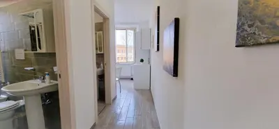 a bathroom with a sink and a toilet and a mirror at Rome Aparts - Deluxe Apartment with 3 bedrooms at St Peter square in Rome