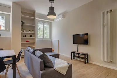 a living room with a couch and a tv at Glorioso Apartment Trastevere in Rome