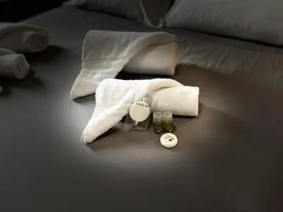 a pile of towels and cosmetics on a bed at La Villa di Roma in Rome