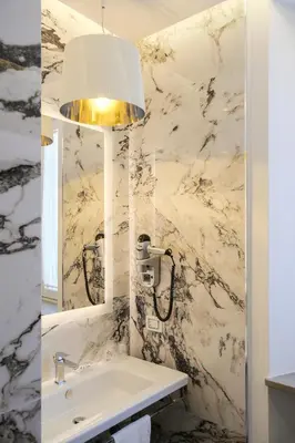 a bathroom with a sink and a mirror at Stendhal Luxury Suites in Rome