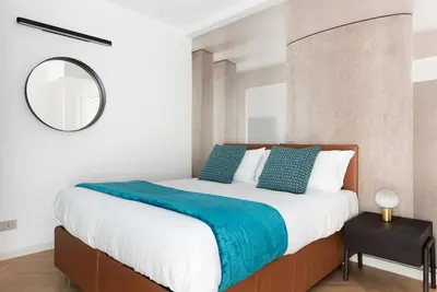 a bedroom with a large bed and a mirror at Idyllia - Maia luxury apartment in Rome