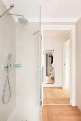 a bathroom with a shower and a mirror at Idyllia - Maia luxury apartment in Rome
