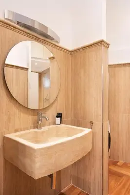 a spiral staircase with a mirror in a building at Idyllia - Vatican Stylish Flat in Rome