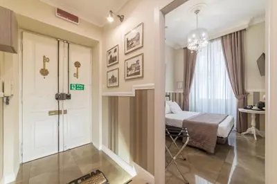 a bedroom with a bed and a table and a window at Le Chiavi di Roma in Rome